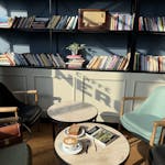 A tranquil café scene in İstanbul with books, coffee, and ambient lighting.