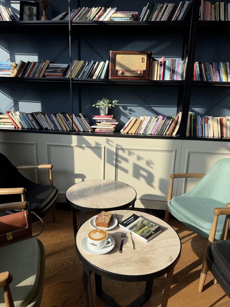A tranquil café scene in İstanbul with books, coffee, and ambient lighting.